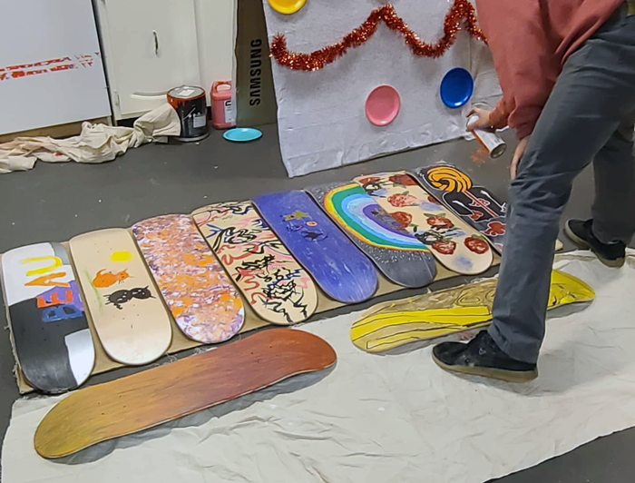 Skateboard decks being painted at OUTLoud North Bay