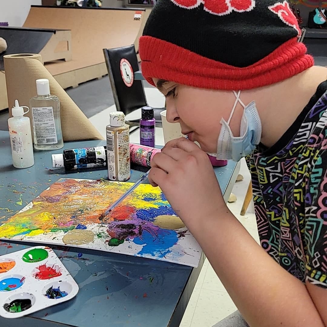 We're looking for people to sponsor a workshop like the art session this young man is enjoying.