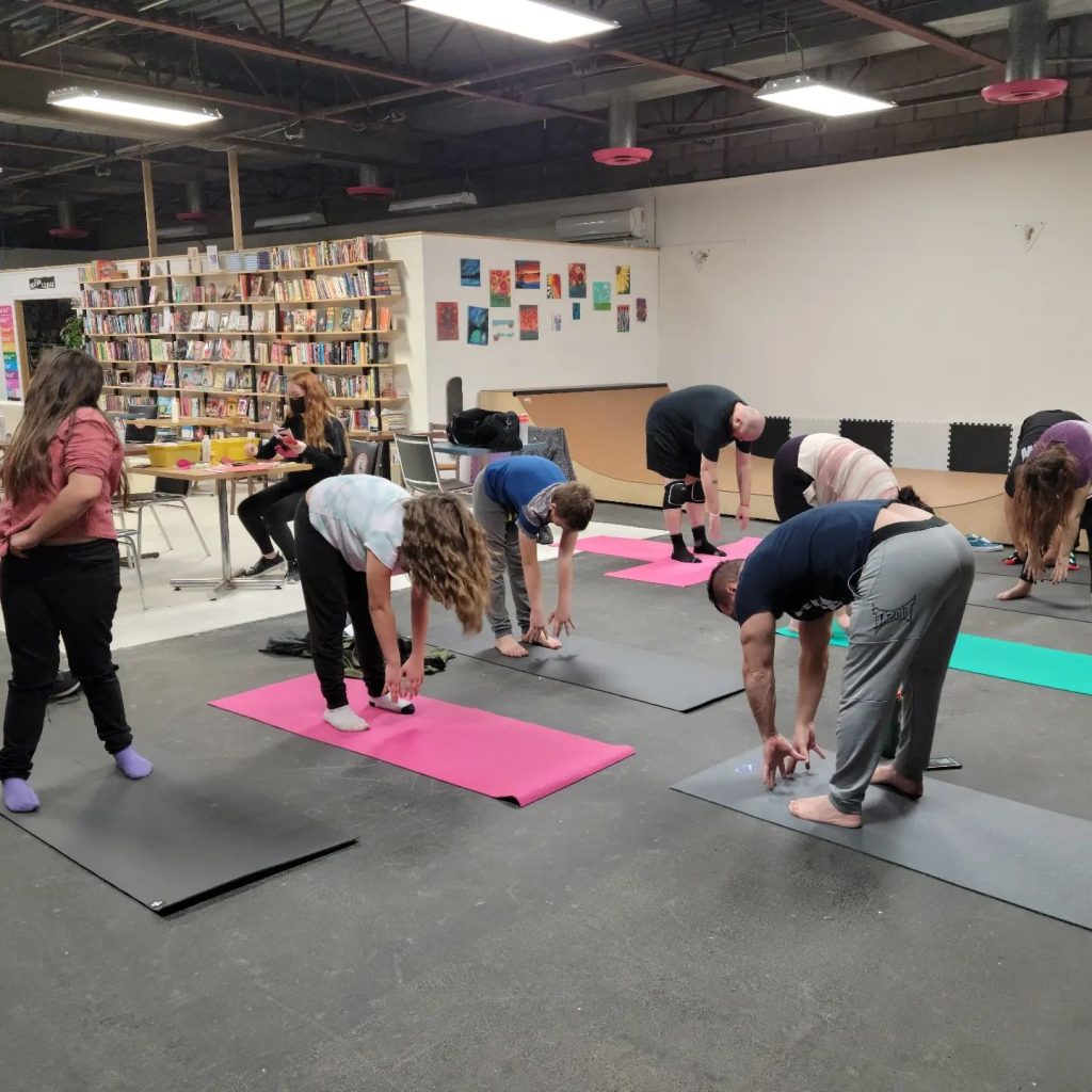 Taking part in wellness workshops - doing yoga together.